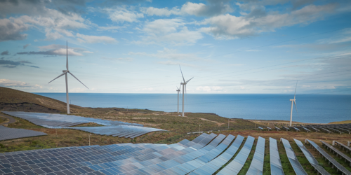 Symbolic image: wind farm and solar farm near the sea 